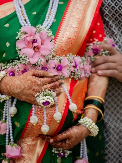 A close-up detail shot of the beautiful floral jewellery, or 'phoolanche dagine', worn by the mother-to-be, highlighting the traditional elements of a Maharashtrian baby shower.