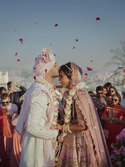 This is the moment. The world fades away, and all that's left is the promise of forever. I strive to create the perfect setting for these priceless memories, where every detail, like the shower of petals, adds to the magic of your love story.