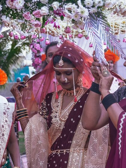 The bride's face, gently veiled, holds a world of emotion. We capture these traditional moments during the ceremony with an eye for detail, preserving the cultural richness and personal significance of each ritual.
