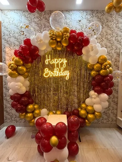 This classic and elegant circular balloon frame is one of my most popular designs for birthdays. The combination of metallic gold, rich red, and crisp white balloons, centered around a glowing neon "Happy Birthday" sign and a gold fringe backdrop, creates a perfect photo opportunity for any age.