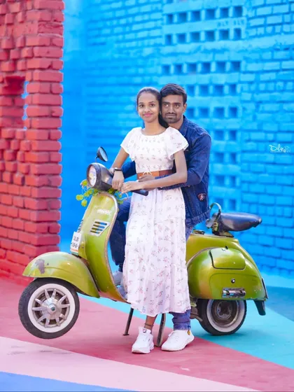A fun and vibrant shot with a green scooter against a colorful red and blue wall.