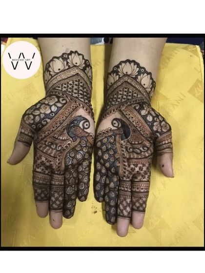 A beautiful design with peacocks as the central focus on the palms.