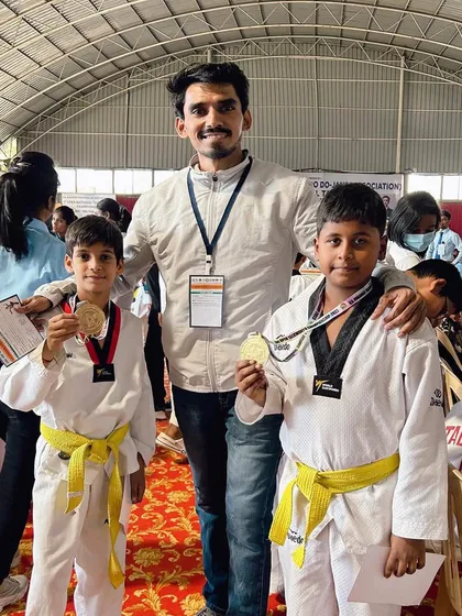 Posing with two of my yellow belt students who won gold at the national championship.