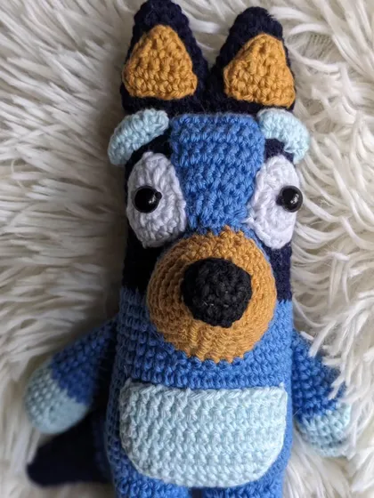 The Bluey doll on a soft white background.