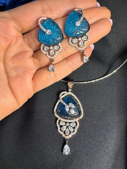 This is a close-up of one of my popular pendant sets, featuring a beautifully carved blue stone surrounded by sparkling American Diamonds. It's a delicate yet eye-catching piece that works wonderfully for both Indian and Western outfits.