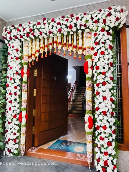 Another angle of the beautiful red and white floral door frame, showing the depth and detail of the flower arrangement.