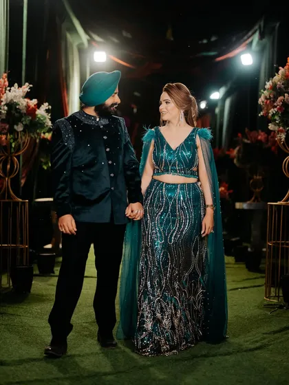 A romantic shot of the couple. The makeup complements her stunning sequined outfit perfectly.