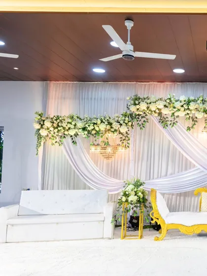 Another angle of the white and gold stage, showing the clean lines and beautiful floral details that create a serene and sophisticated atmosphere.