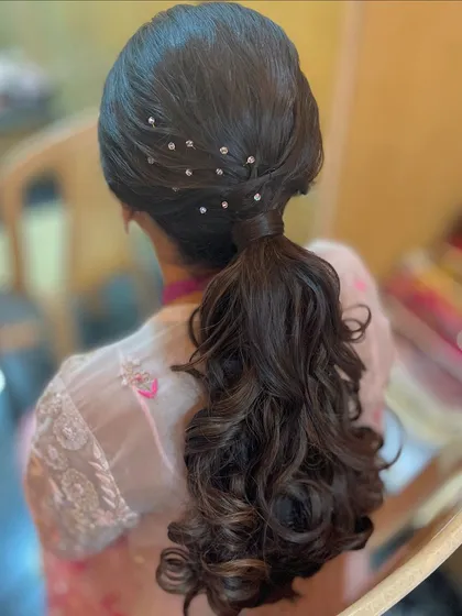 A chic ponytail with a sprinkle of delicate crystal accessories for a touch of sparkle.