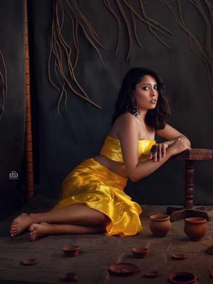 A wide shot of the rustic studio setup, showing the model surrounded by terracotta pots. This image highlights my ability to create a complete, narrative-driven scene within the studio.