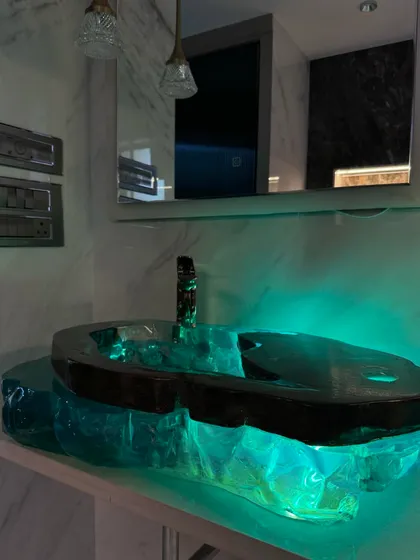 A stunning shot of the backlit resin washbasin installed in a client's bathroom. This piece truly speaks the language of exclusivity.