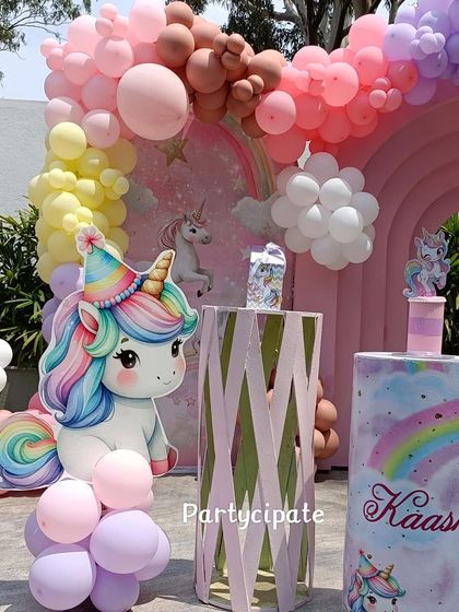 A close-up of the unicorn party decor, featuring a cute unicorn cutout and a custom-printed plinth with the birthday girl's name.