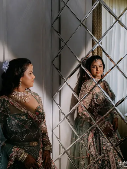 A bride's reflection. The use of mirrors and reflective surfaces in the decor adds depth and creates unique photo opportunities.