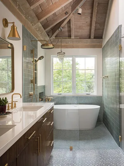 Bathrooms are mood-lifters. In this Saratoga home, the master bath was designed to be a spa-like escape, with a freestanding tub overlooking the lush hillside. The mix of wood, brass fixtures, and textured tiles creates a feeling of quiet, functional luxury.