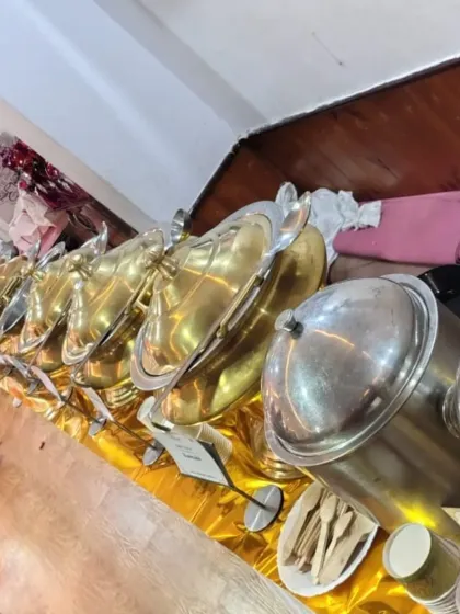 A close-up view of our gleaming brass and steel serving dishes, ready for a luxury event. We believe the quality of our equipment reflects the quality of our food.