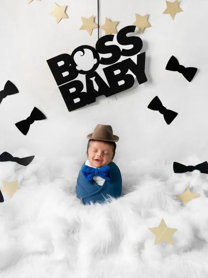 The boss is in. Adding a tiny hat completes the look for this adorable "Boss Baby" newborn shoot, adding an extra layer of character and humor.