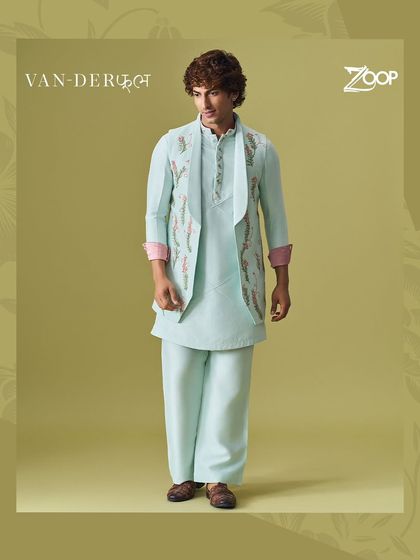 A full-length view of the light blue Vanderphool kurta set. The asymmetrical jacket design and contrasting cuffs add a contemporary edge to this traditional outfit.