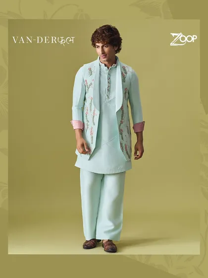 A full view of the pastel blue Vanderphool kurta set. The asymmetrical jacket design and floral embroidery create a unique silhouette that is both modern and elegant.