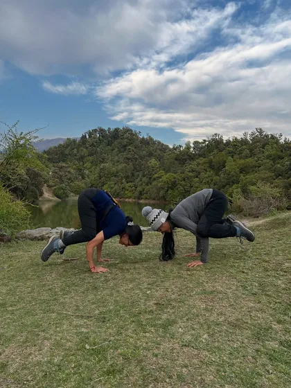 Partnering up for Bakasana (Crow Pose) practice. Working with a partner can help build confidence and provide the support needed to nail challenging arm balances.