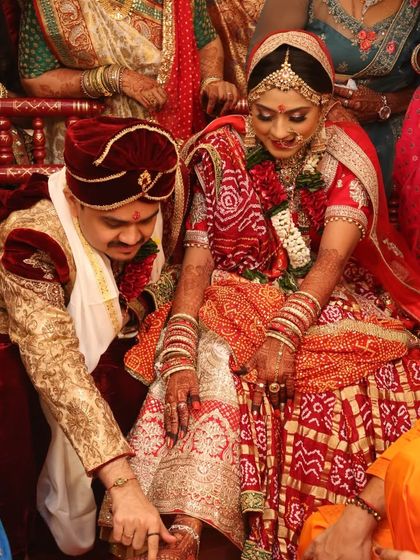 A traditional wedding ritual where the groom adorns the bride's feet. Her intricate foot mehndi adds to the beauty of this special moment.