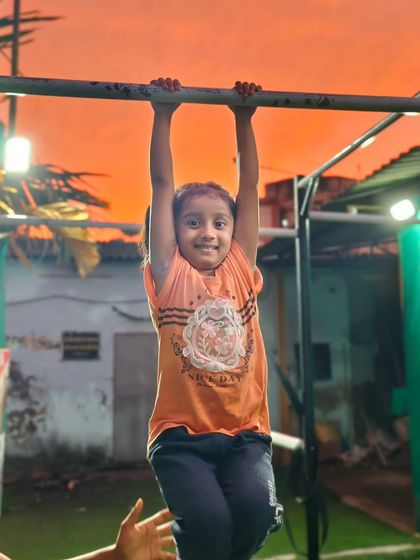 A smile of pure joy during our sunset session. This young girl loves training on the bars as the day comes to a close.