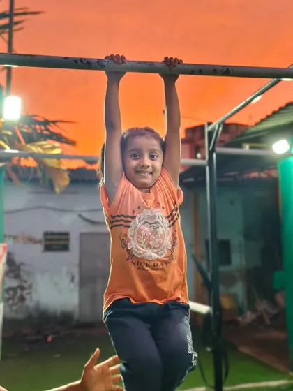 A smile of pure joy during our sunset session. This young girl loves training on the bars as the day comes to a close.