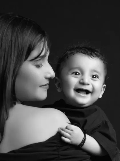 In this timeless black and white portrait, a mother gazes at her baby, whose face is lit with a radiant, innocent smile. This is prem ki pehli tasvir, the first picture of love, a quiet moment that holds the universe of their bond.