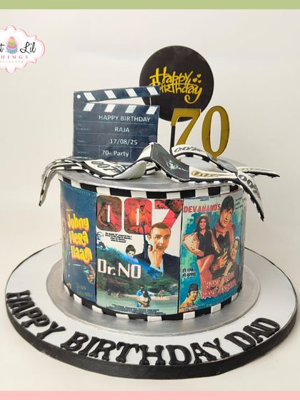 A blockbuster 70th birthday cake for a movie-loving dad. This cake is wrapped in edible posters of classic Bollywood films and topped with a movie clapperboard.