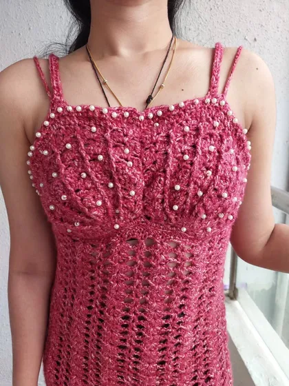 A close-up of the shell-stitch bust with hand-sewn pearl details on the Sirena Dress.