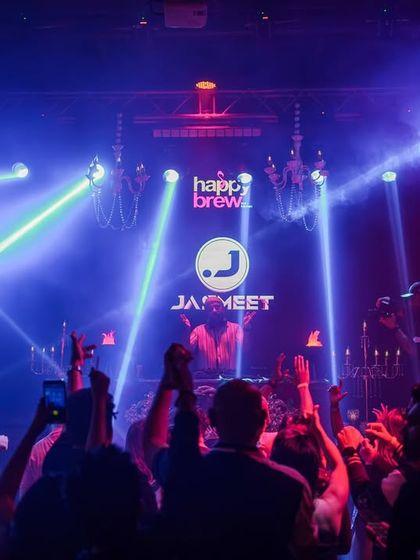 A wide shot of the laser light show and packed crowd at Happy Brew.