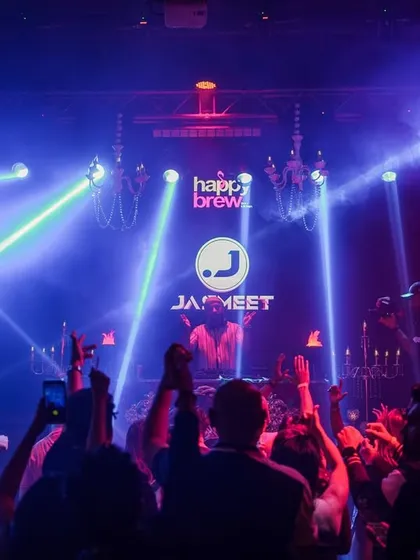 A wide shot of the laser light show and packed crowd at Happy Brew.