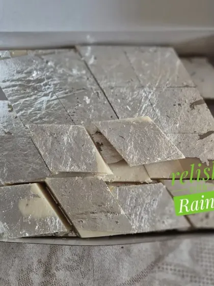 Another view of the Kaju Katli with silver vark, showing the classic diamond shape and smooth finish.