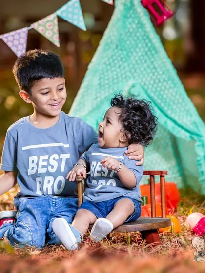The pure love between brothers shines through in this outdoor sibling photoshoot. Set against a playful teepee backdrop, their matching "Best Bro" shirts and genuine laughter make for a priceless memory.