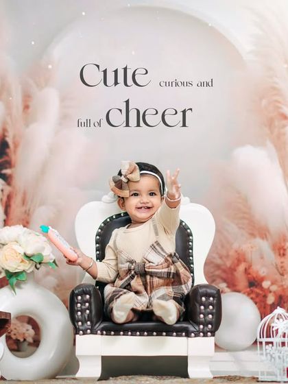 A cheerful first birthday portrait in our boho-chic studio. The little girl's peace sign and bright smile perfectly capture the fun of the moment.