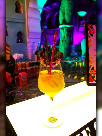 My 'Mango Manifested Love' cocktail, a tropical delight served in a wine glass. It's a perfect, refreshing choice for daytime events and summer weddings.