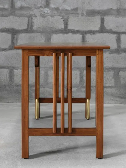 Introducing the Madhu Study Table, a statement of discerning aesthetics and master craftsmanship. The harmonious blend of solid teak and brass accents makes it a versatile addition to any interior style.