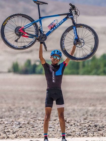 A rider with his Btwin Rockrider mountain bike, perfectly at home in the rugged, off-road terrain. This is what shredding the trails looks like.