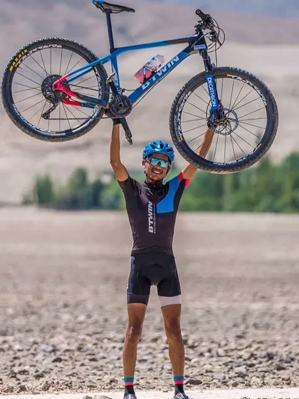 A rider with his Btwin Rockrider mountain bike, perfectly at home in the rugged, off-road terrain. This is what shredding the trails looks like.