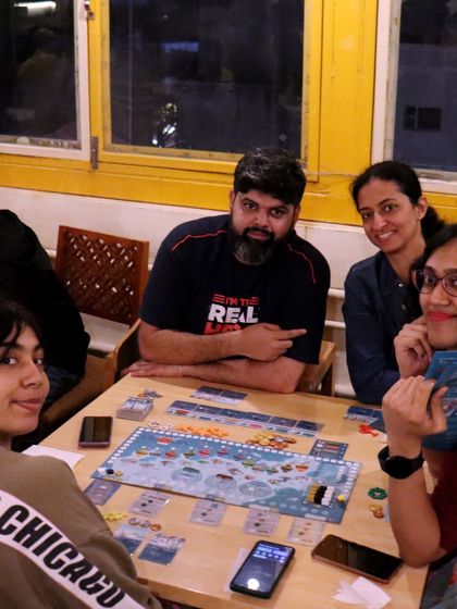 The focus is real. This group is deep into a game, showing the fun and competitive spirit of our board game community.