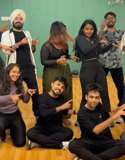 The whole squad pointing at the camera. It's all about that shared energy and fun.