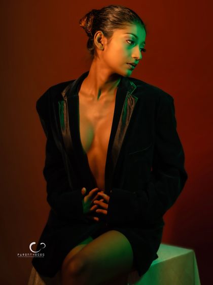 A thoughtful and elegant pose. The composition is clean, and the lighting is the star of the show.