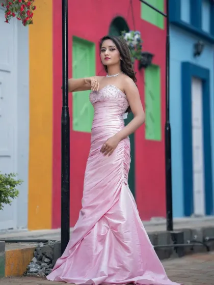 The model posing against a colourful background, showing the versatility of the makeup.