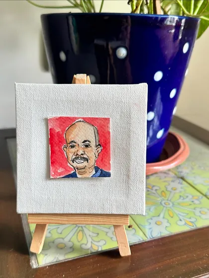 My mini portrait of Rupesh displayed on an easel.