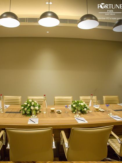 The thoughtful details in my conference room, like the floral centerpieces and organized seating, ensure a professional and welcoming atmosphere for all your corporate events.