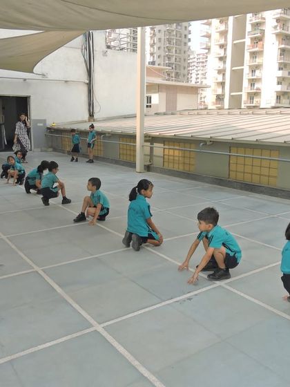 Students getting ready for a game of Kho-Kho on our rooftop court, demonstrating their readiness and enthusiasm for sports.