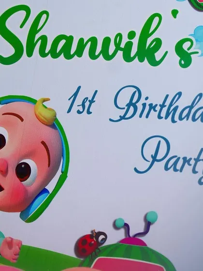 A close-up of the personalized welcome sign for Shanvik's Cocomelon-themed first birthday party, featuring the main character, JJ.