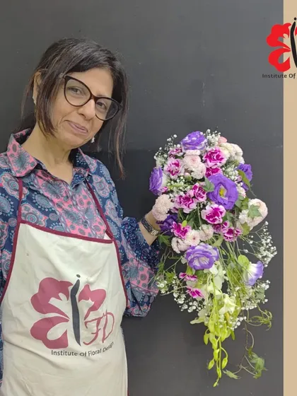 This student created a vibrant cascading bouquet with purple lisianthus and pink carnations. Learning to combine bold colors is a key part of our curriculum on color theory in floral design.
