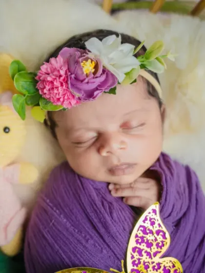 A butterfly kiss in a floral wonderland. The vibrant purple and pink flowers in this setup make the portrait pop with color and life.