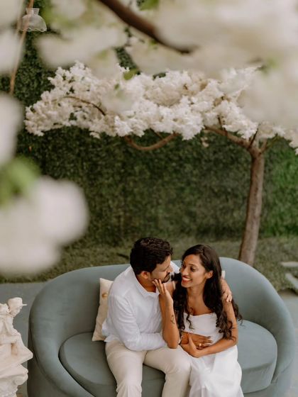 A sweet, candid moment on a sofa during a studio pre-wedding session. The soft lighting and gentle interaction make this feel very personal.