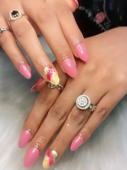 A pretty pink set with abstract red and yellow watercolor accent nails. This is a great way to add a pop of color and an artistic touch.